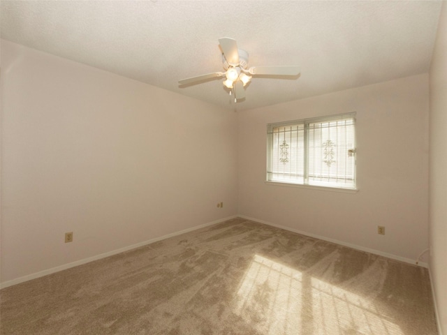 empty room featuring carpet floors and ceiling fan