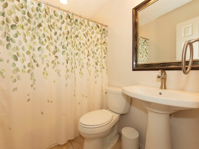 bathroom with tile patterned flooring and toilet