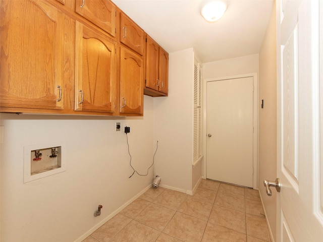 clothes washing area with cabinets, hookup for an electric dryer, washer hookup, and light tile patterned floors