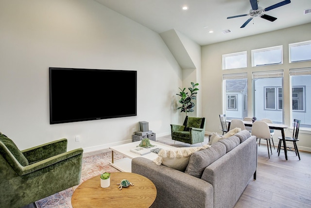 living room with ceiling fan and light wood-type flooring