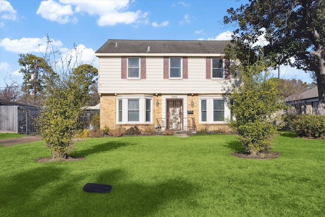 colonial inspired home featuring a front yard