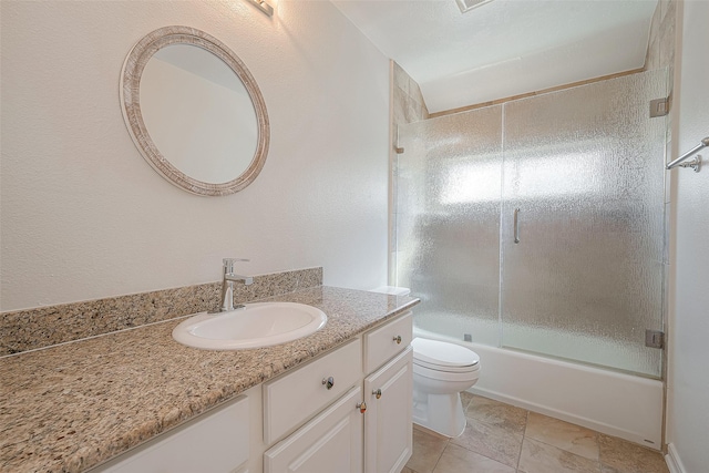 full bathroom with bath / shower combo with glass door, vanity, and toilet