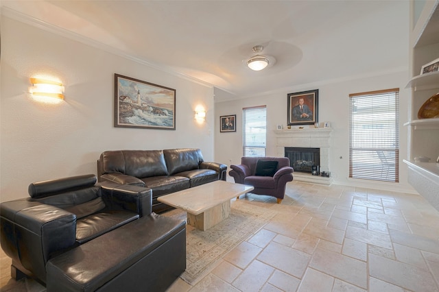 living room with ornamental molding and ceiling fan