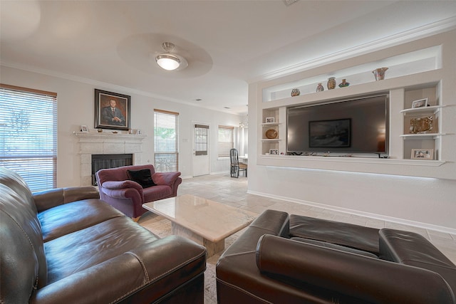 living room featuring crown molding, ceiling fan, and built in shelves