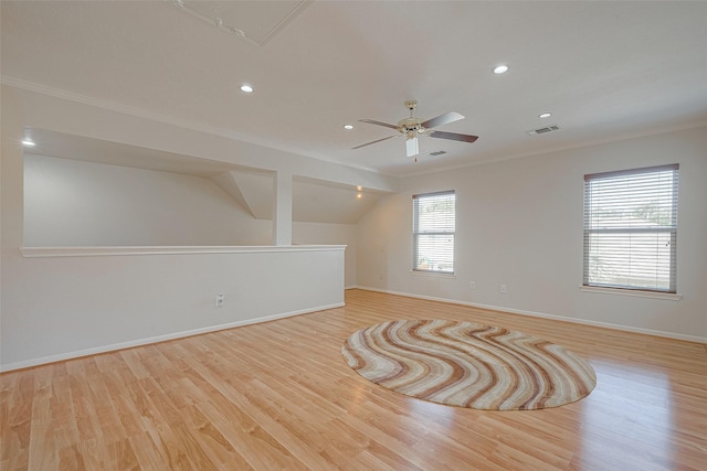 empty room featuring crown molding, ceiling fan, lofted ceiling, and light hardwood / wood-style flooring