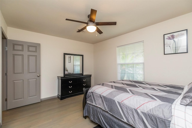 bedroom with light hardwood / wood-style floors and ceiling fan