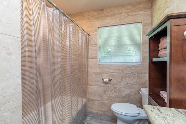 bathroom featuring walk in shower and toilet