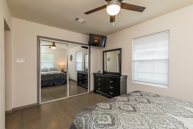 bedroom with dark hardwood / wood-style flooring, a closet, and ceiling fan