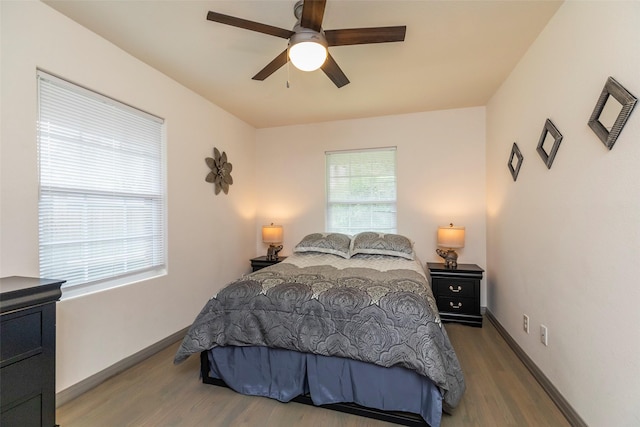 bedroom with ceiling fan and wood-type flooring