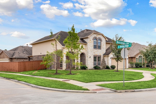 view of front of house featuring a garage and a front yard