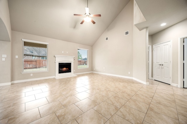 unfurnished living room featuring high vaulted ceiling, light tile patterned floors, and ceiling fan