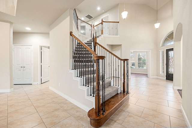 tiled entryway featuring a high ceiling