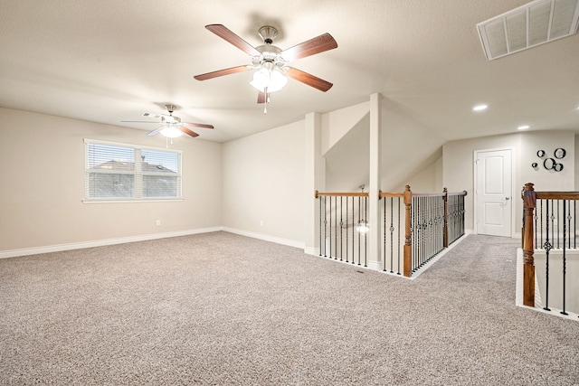 spare room with vaulted ceiling and carpet