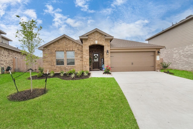 view of front of home with a garage and a front lawn