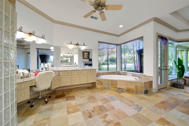 bathroom featuring vanity, crown molding, and tiled bath