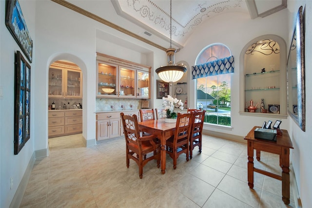 dining room featuring lofted ceiling, brick ceiling, and light tile patterned flooring