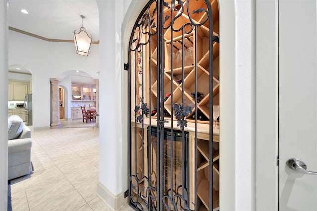 wine cellar featuring crown molding and tile patterned floors