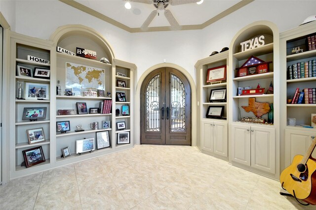 entryway featuring ornamental molding and french doors