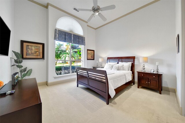 bedroom featuring crown molding, a towering ceiling, light colored carpet, and ceiling fan