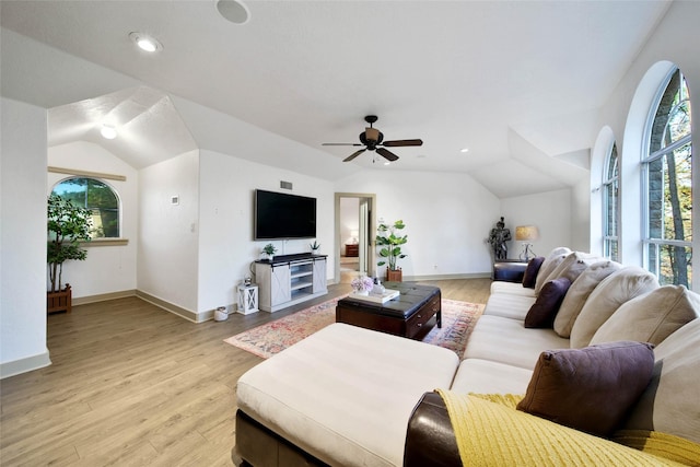 living room featuring lofted ceiling, ceiling fan, and light wood-type flooring