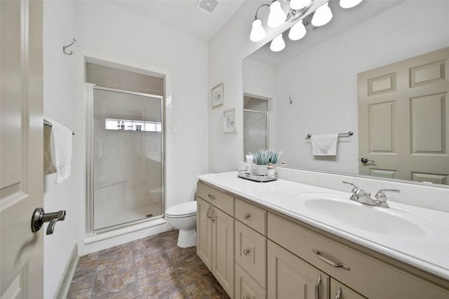 bathroom with vanity, an enclosed shower, and toilet