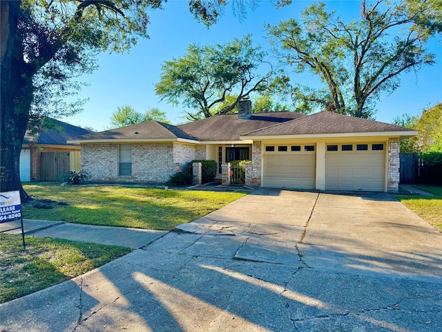 single story home featuring a garage and a front lawn