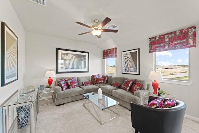 carpeted living room featuring vaulted ceiling and ceiling fan