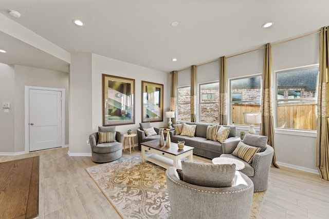 living room with plenty of natural light and light hardwood / wood-style floors