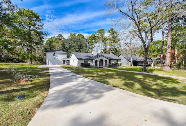 view of front of home with a garage and a front lawn