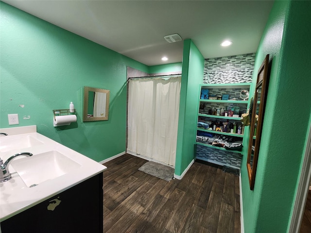 bathroom featuring wood-type flooring, curtained shower, and vanity