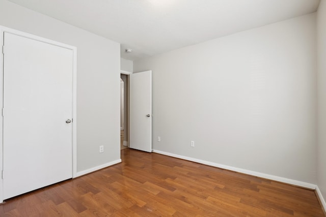 unfurnished bedroom featuring hardwood / wood-style flooring