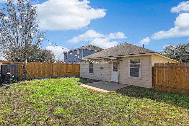 rear view of house with a lawn and a patio area