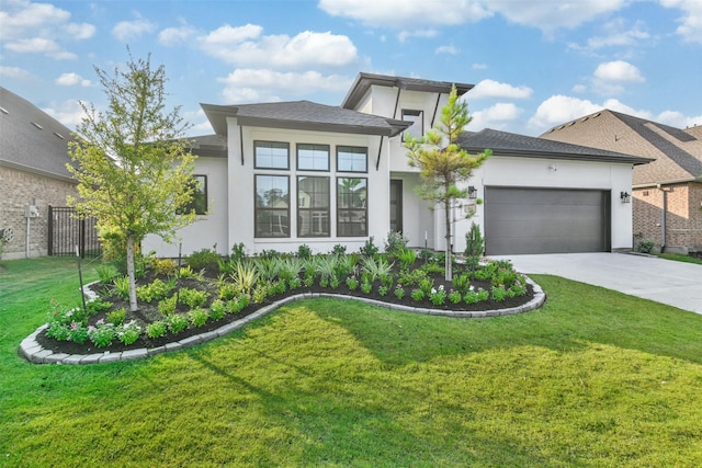 prairie-style home featuring a garage and a front lawn