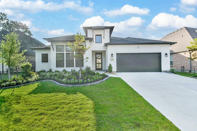 view of front facade with a garage and a front lawn