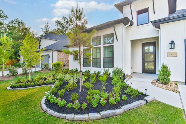 doorway to property featuring a lawn