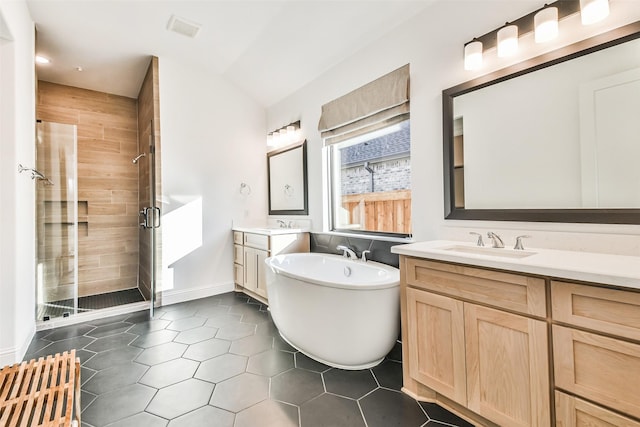 bathroom with tile patterned floors, separate shower and tub, and vanity