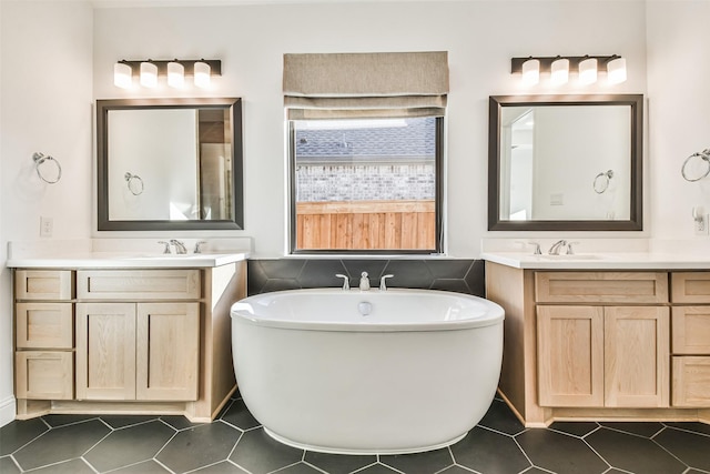 bathroom featuring vanity, a bathing tub, and tile patterned flooring