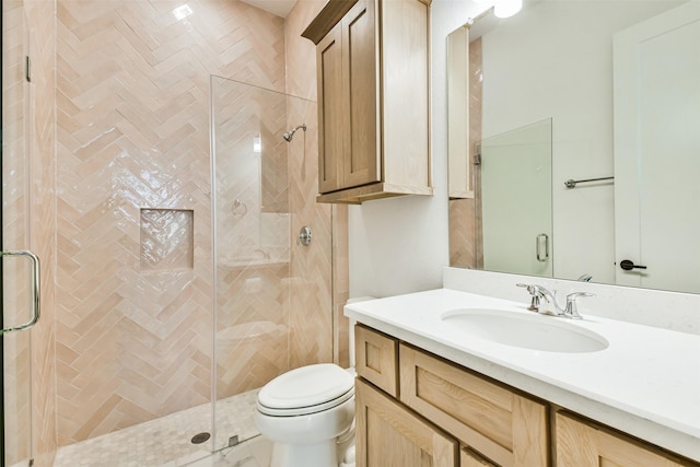 bathroom with vanity, an enclosed shower, and toilet