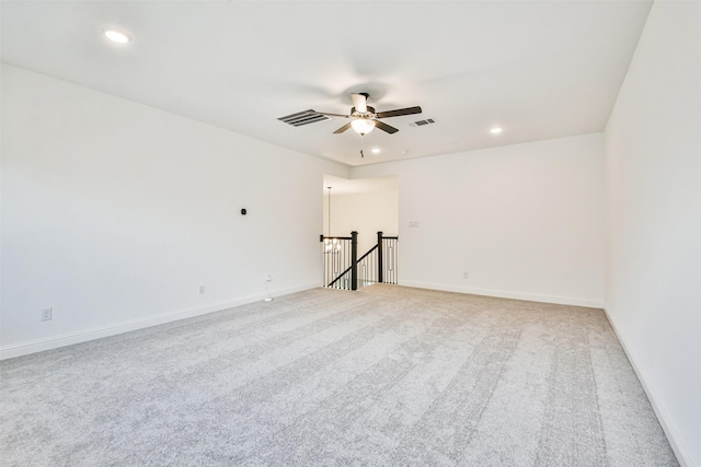 spare room with light colored carpet and ceiling fan