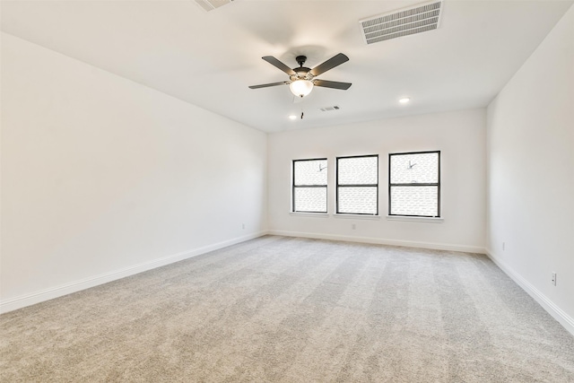 spare room featuring ceiling fan and light colored carpet