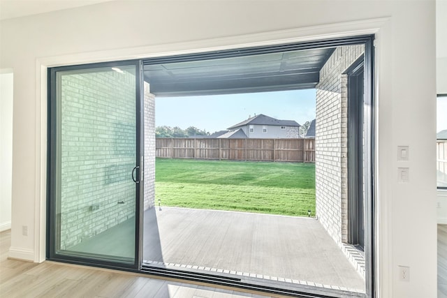 doorway to outside featuring wood-type flooring