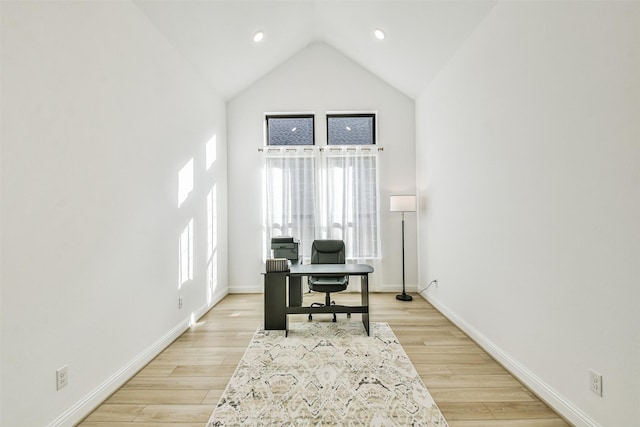 office area featuring lofted ceiling, plenty of natural light, and light wood-type flooring