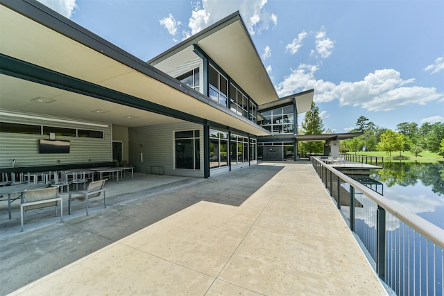 exterior space with a water view and a patio