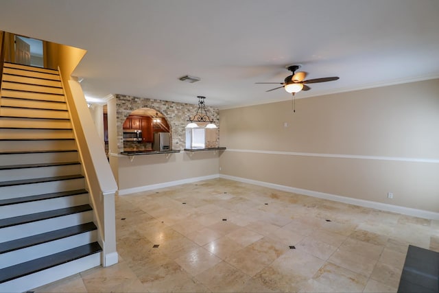 interior space with ornamental molding and ceiling fan