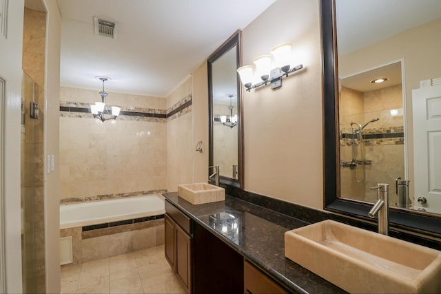 bathroom featuring vanity, independent shower and bath, and a chandelier