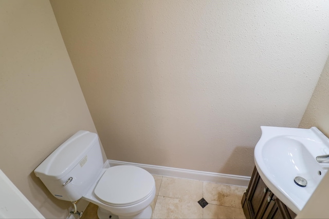 bathroom featuring sink, tile patterned floors, and toilet