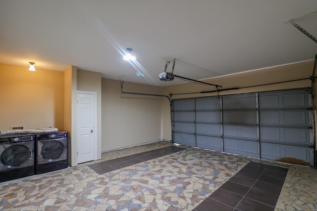 garage with a garage door opener and washing machine and dryer