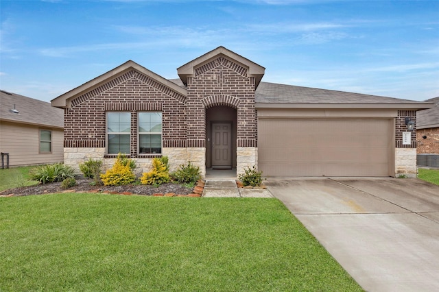 view of front of home with a garage and a front lawn