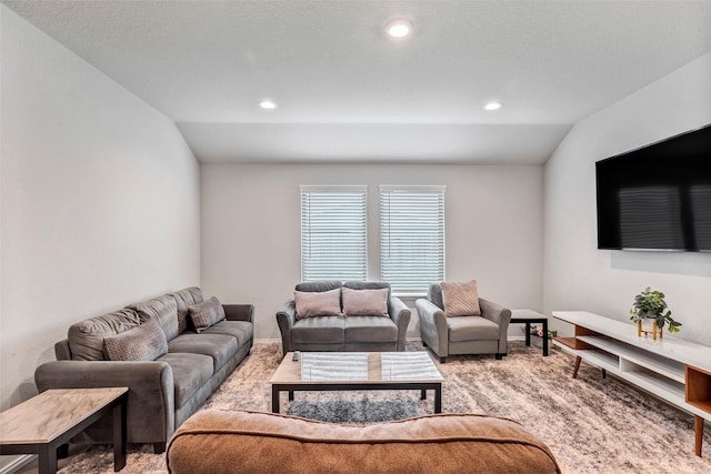 carpeted living room featuring lofted ceiling