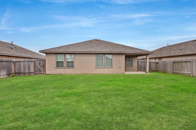 back of property with a yard and a patio area